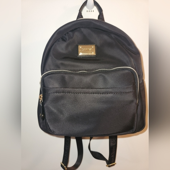 Calvin Klein Handbags - Calvin Klein Black Backpack with Gold Zippers and Smooth Finish